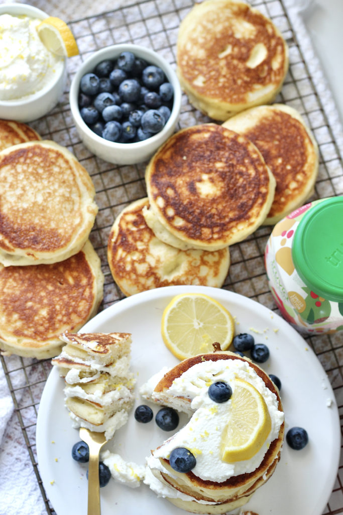 lemon ricotta pancakes on gold baking rack with truvia and blueberries