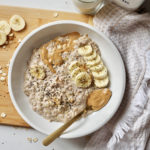 banana peanut butter overnight oats in white bowl with kefir
