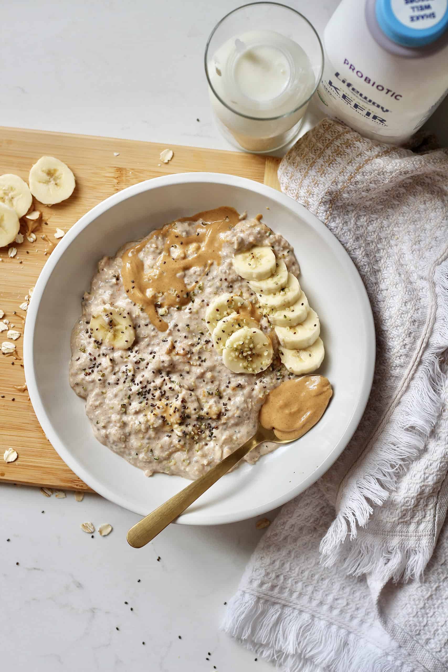 banana peanut butter overnight oats in white bowl with kefir