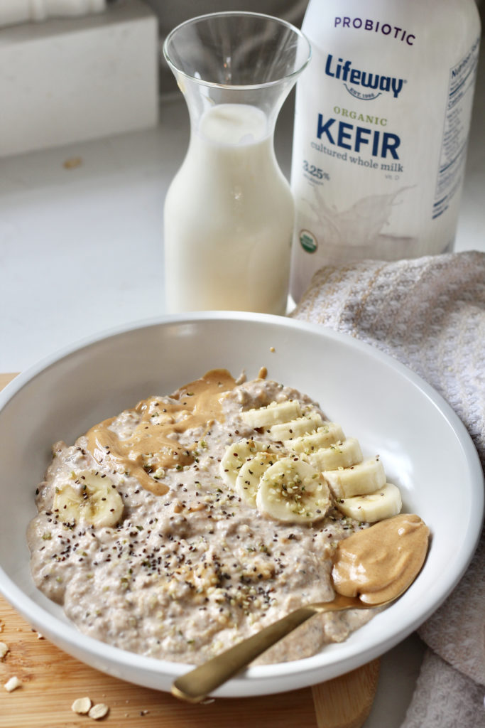 peanut butter overnight oats in white bowl with bananas