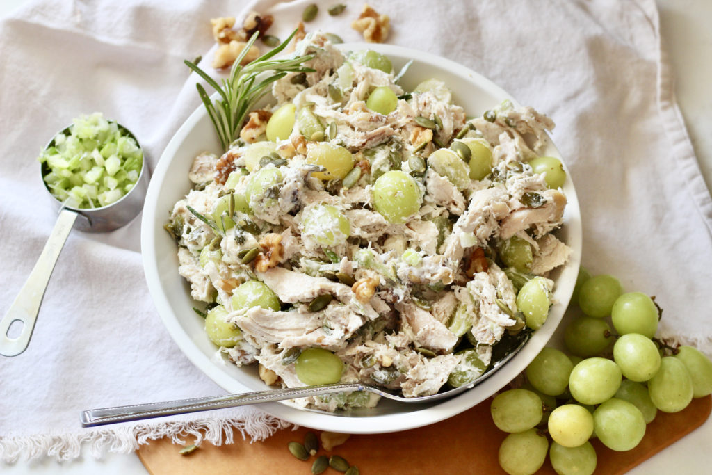 chicken salad with grapes and walnuts silver serving spoon white lecreuset serving bowl