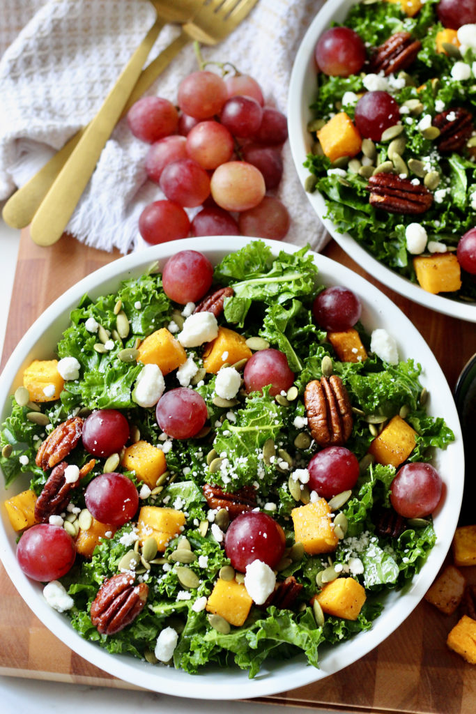 fall harvest salad in white lecreuset bowl with grapes butternut squash goat cheese and pecans