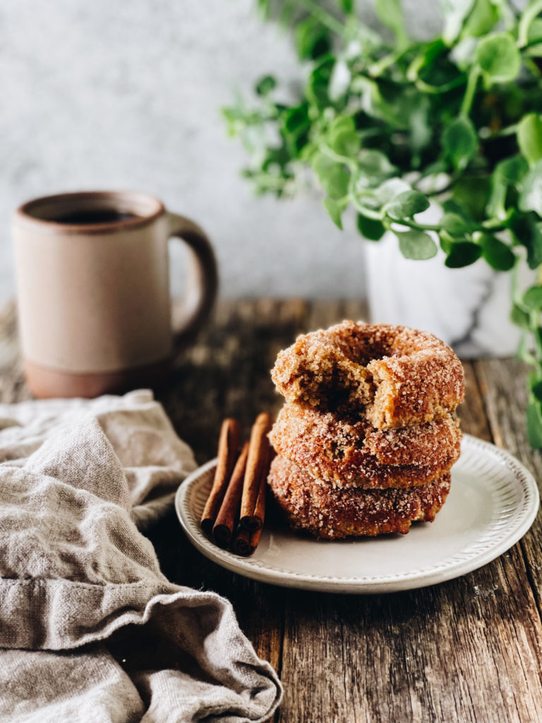 stck of three cinnamon sugar donuts and coffee