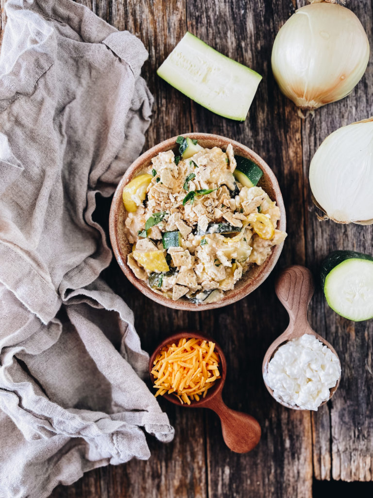 bowl of zucchini and squash casserole with shredded cheese and cottage cheese