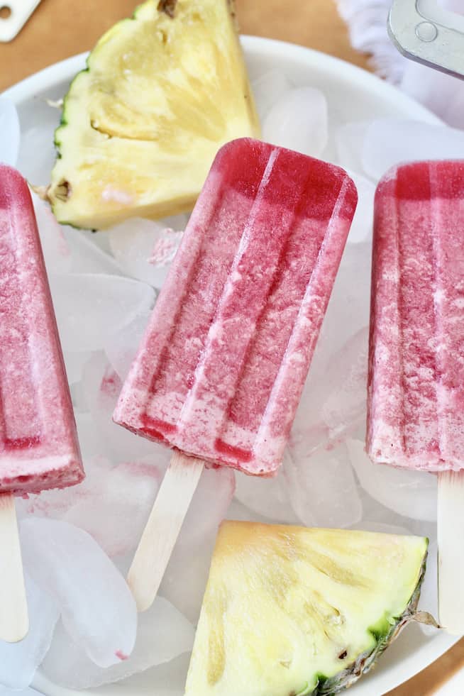 pineapple cherry popsicles 9 | Milk & Honey Nutrition pineapple cherry popsicles and pineapple slices in bowl of ice