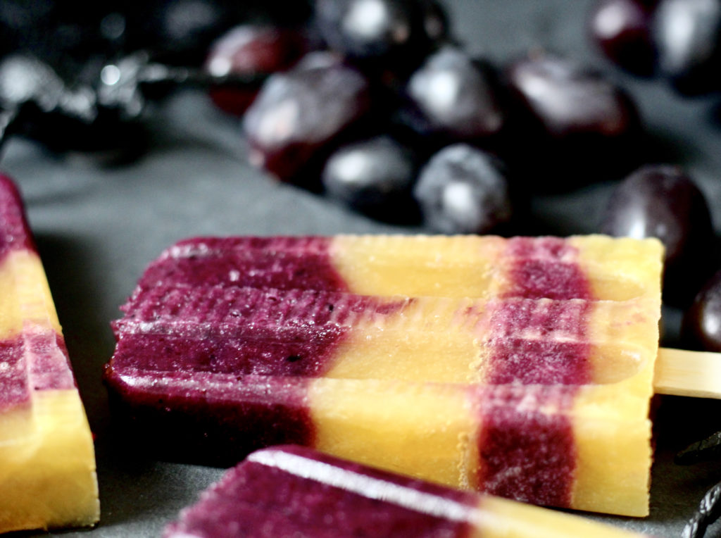 orange juice and black grape popsicles