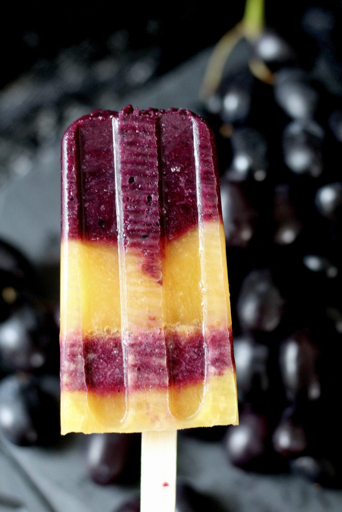 orange juice and black grape popsicles