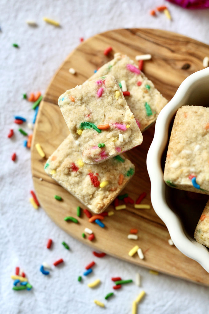 heavenly hunks birthday cake bites on wood cutting board with sprinkles