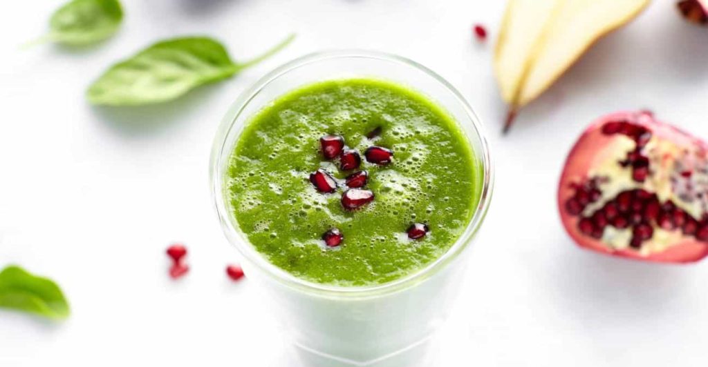 green smoothie with pomegranate seeds
