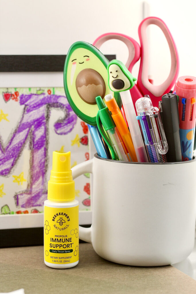 bee propolis throat spray on desk with avocado squishy pen