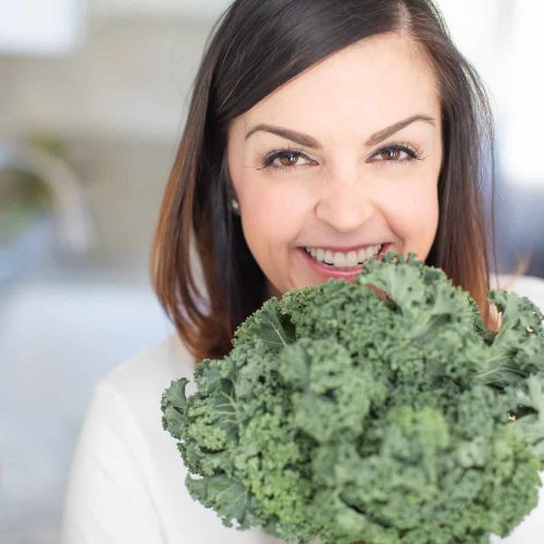 close up picture of Mary Ellen Phipps with a bunch of kale
